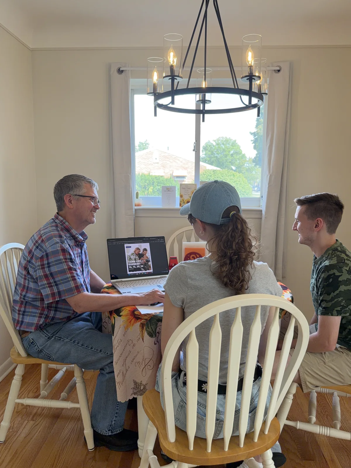 Tim Coates talking with two people around a dining table